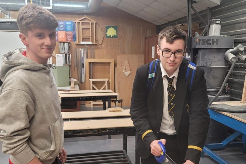 Northern Regional College Joinery apprentice Fynn O'Neill helps Calum Leacock from Magherafelt High.