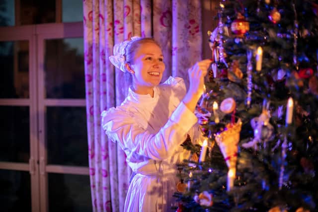 An explainer dresses a Christmas tree in the State Drawing Room, in preparation for a Victorian Christmas at Hillsborough Castle