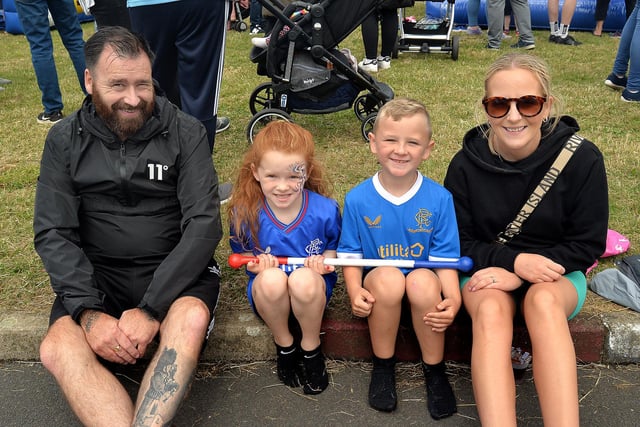 Having a break from all the activities at the Edgarstown fun day on July 11 are from left, James Reid, Taylor Reid (5), Danny Blevins (7) and Jacqueline Reid. PT27-296.