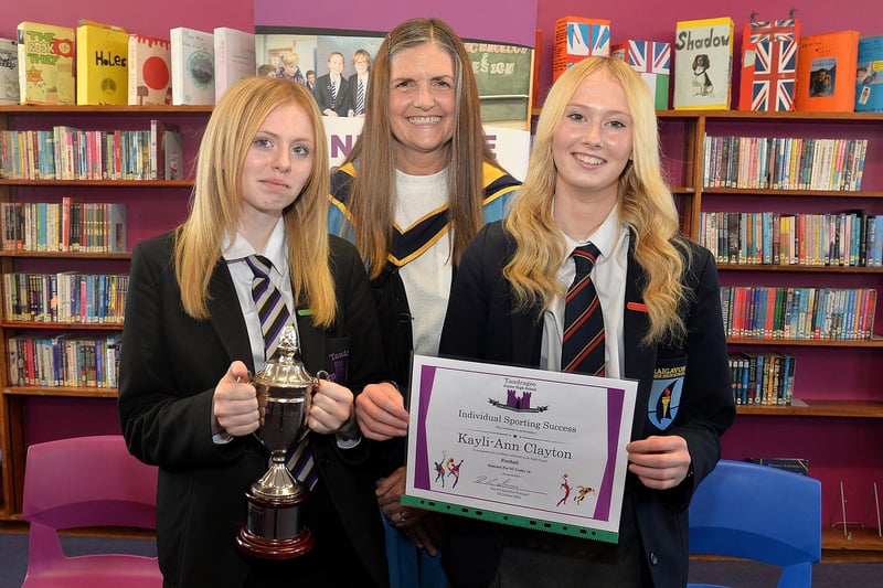 Sisters Caycie Clayton, left, Year 7 Sports Champion, and Kayli-Ann Clayton, NI Under 16 team member pictured with vice principal Mrs Laverne Inns at the  Tandragee Junior High School prize day. PT44-208.