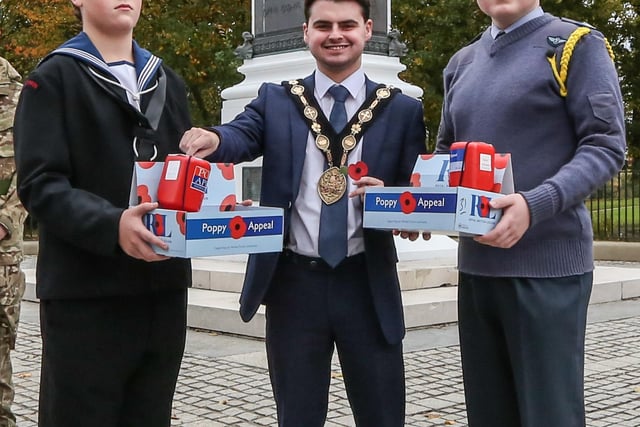 The Mayor of Lisburn and Castlereagh, Councillor Kurtis Dickson buys the first poppy of the year