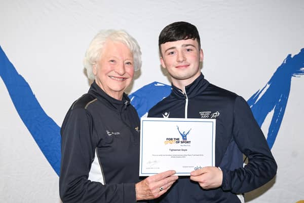 Tighearnan is pictured receiving his award certificate from Lady Mary Peters. (Pic: Contributed).