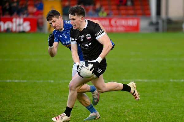 Miceal Rooney races past Scotstown's Darren Hughes at Pairc Esler when the sides met last year in the Ulster quarter-final. Pic: Brendan Monahan