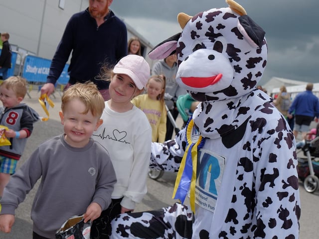 Hallie Cole, 6, and Marcus Cole, 3, from Bangor meet Northern Ireland Kidney Research Fund 's mascot Bella the Kidney Cow.
