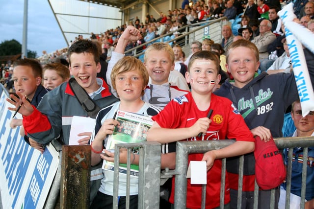 Manchester United supporters who watch their team beat Benfica in the semi-finals of the Milk Cup in 2010