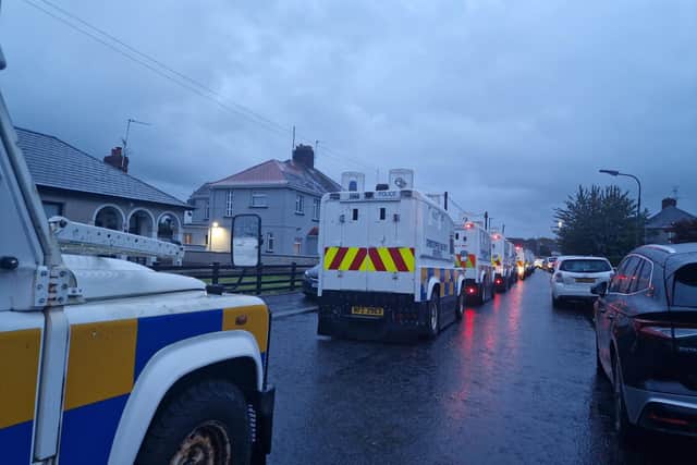 PSNI Land Rovers lined up and waiting in a side street off the Garvaghy Road in Portadown as protesters filled the road. They were protesting at the Parades Commission determination to permit Portadown Orange District to march through the Garvaghy Road.