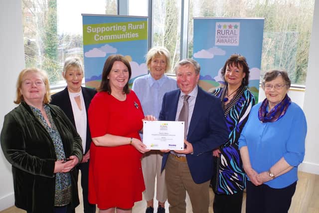 Sammy Wilson, winner of the Housing Executive’s Rural Community Champion Award 2022, south region, receives his plaque from Housing Executive Chair Nicole Lappin at the recent awards ceremony. Also present are members of the Donaghmore Horticultural Community and Sharon Crooks, the Housing Executive’s area manager for Mid-Ulster.