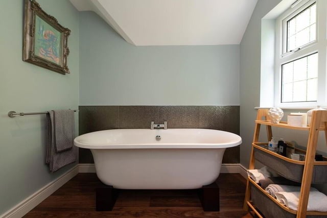 Luxury bathroom with roll-top bath.