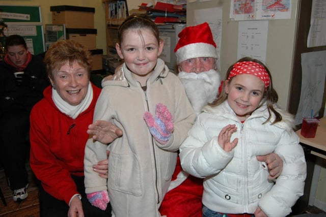 Santa with Kate McClure and Paula and Lauren at the Glenarm Christmas tree lights switch on in 2006. LT50-387-PR