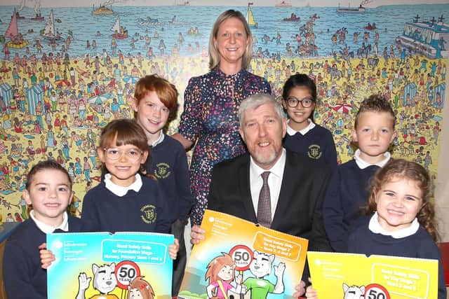 Infrastructure Minister John O’Dowd visited Dunmurry Primary School to mark the 50th Anniversary of the Road Safety Teaching Aid Calendar.  The Minister is pictured with school principal, Mrs Judith Hackett and pupils (from left to right) Jaxx Owen; Evie McCaughey; Rory Minnick; Sonika Chimanya; Jake Green; and Harper Williamson.