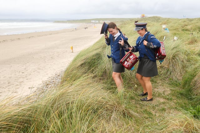 Bamd members make their way through the dunes to the beach