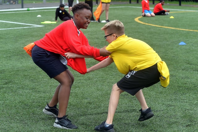 Hart and Presentation Primary School pupils tussle during a game of 'rip the tail off the fox' during the joint fun day. PT24-208.