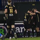 Larne players celebrate at Mourneview Park. (Pacemaker Press).