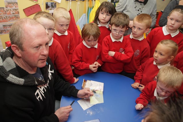 PRINT IT. PSNI Sgt Clive Elliott, pictured along with P2/3 pupils at the Eden PS in 2010 showing them how fingerprints are taking during a talk and demonstration about investigating and observations skills.