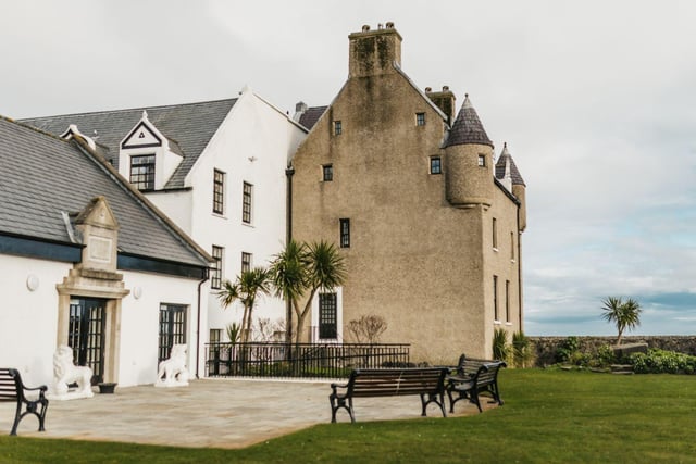 Ballygally Castle is centuries old and currently stands as a hotel. It's said to be one of the most haunted places in all of Ulster. The ghostly castle was built back in 1625 by John Shaw of Greenock and was later restored in 1760 by relative James Shaw and his wife Isabella Brisbane. After many owners over the years, Ballygally Castle was transformed into a hotel with some ghostly guests. 
Ballygally’s most famous phantom is that of Lady Isabella Shaw who suffered great trauma within the castle walls. It is said after Lady Isabella gave birth to her daughter, her husband Lord James Shaw took the baby from her and left her locked in a small room and starved. After hearing her baby in distress, Isabella attempted to escape through a window, but unfortunately fell to her death. It is rumoured that Lady Isabella wanders the hotel hallways, knocking on doors in search of her baby girl. 
In recent years it's been said that guests visited the turret room after hearing the fascinating story, but when entering the Ghost Room a previously smiling 18-month old child became hysterical with terror. A former nineteenth century castle resident, Madame Nixon is also reported to still be wandering the corridors, with her silk skirts heard rustling as she walks through the night.