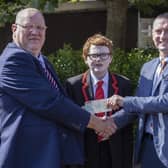 Graeme Watton presents Mr. Ricky Marsh, Principal, Coleraine College, with a donation of £1,350 towards the school's Learning Support Unit. Included is Greame's son Jude, who benefited from the Unit during his time at Coleraine College. Credit McAuley Multimedia