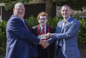 Graeme Watton presents Mr. Ricky Marsh, Principal, Coleraine College, with a donation of £1,350 towards the school's Learning Support Unit. Included is Greame's son Jude, who benefited from the Unit during his time at Coleraine College. Credit McAuley Multimedia