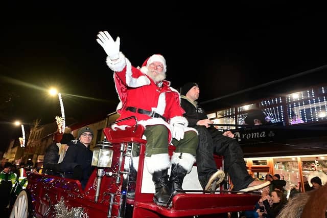 Santa arrives in style to switch on the Christmas lights.