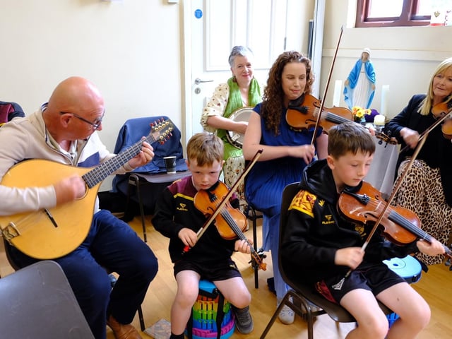 Some young musicians entertaining guests after an International Mass at St Peter's Church in Lurgan, Co Armagh.