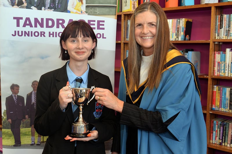 Former Tandragee Junior High School pupil, Lotus Clark is presented with the trophy for academic achievement by vice principal, Mrs Laverne Inns at the school prize day. PT44-211.