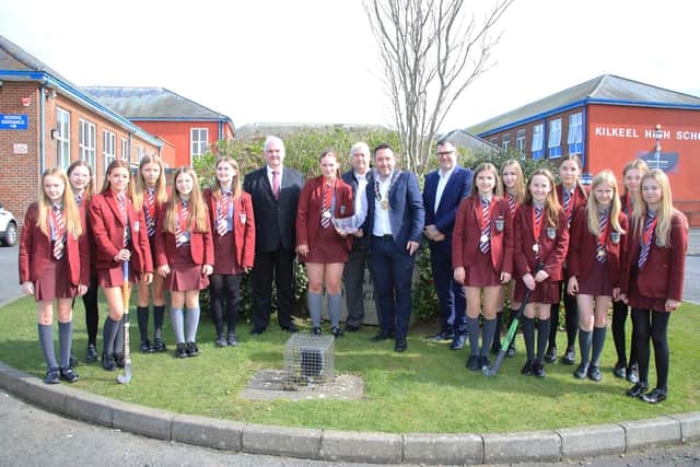 Under 14 Captain Carly Houston accepts the inscribed crystal Bowl from Council Chairperson Councillor Pete Byrne Hockey Team now Ulster Champions.