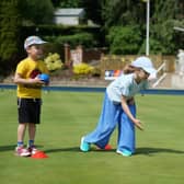 Some young children try their hand at bowls at the open day.