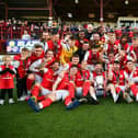 Celebration time for Larne FC as the team receives the Gibson Cup at Inver Park. Photo: Andrew McCarroll / Pacemaker