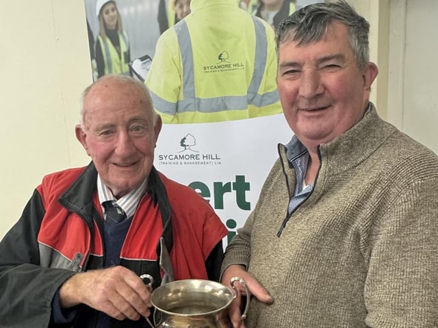 Society President Dai Kennedy is presented his trophy for Most Senior Competitor by host Mr James Baird at Listooder Ploughing match