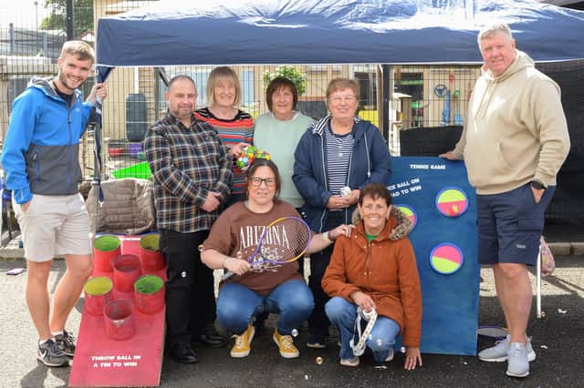 Pictured at the Millburn Smile Project’s fun day are (back row from left) Joel Cromie, Housing Executive Patch Manager, Gareth Doran, Housing Executive Good Relations Officer, Jenny Millar, Margaret Glendinning, Stella Boyd, Millburn Community Association, Billy Ellis, Millburn Community Outreach worker.  Including (front row from left) Karen Douglas and Marilyn Donaghy of Millburn Community Association. Credit NI Housing Executive