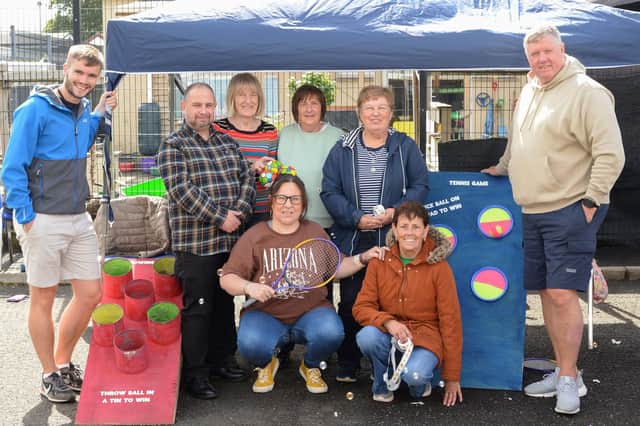 Pictured at the Millburn Smile Project’s fun day are (back row from left) Joel Cromie, Housing Executive Patch Manager, Gareth Doran, Housing Executive Good Relations Officer, Jenny Millar, Margaret Glendinning, Stella Boyd, Millburn Community Association, Billy Ellis, Millburn Community Outreach worker. Including (front row from left) Karen Douglas and Marilyn Donaghy of Millburn Community Association. Credit NI Housing Executive