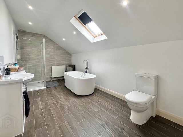 Bathroom with contemporary four piece white suite.