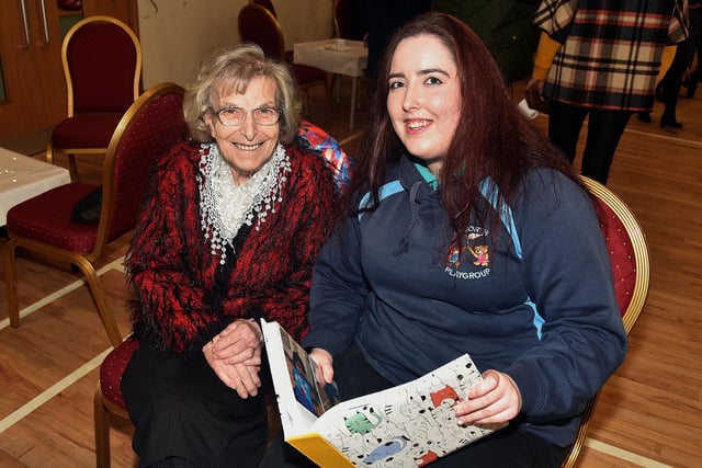 Looking at some photos at the Epworth Playgroup 10th anniversary coffee morning are Beatrice Black, left, and Emily Thompson, playgroup assistant. PT48-230.