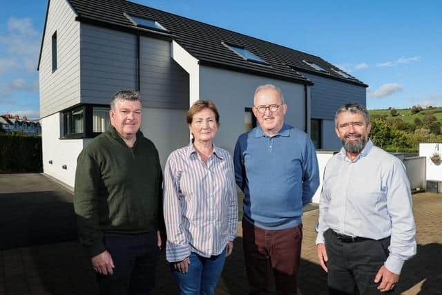 Smart living and lower running costs: pictured (from left) Niall Gribbin, Director of Setanta Construction; homeowners Anne-Marie and Eddie McGoldrick; and Mark Gribbin, Director of Setanta Construction outside the McGoldrick’s full-electric, smart tech home that costs £44 per week to run, including electric vehicle charging.Credit: Supplied
