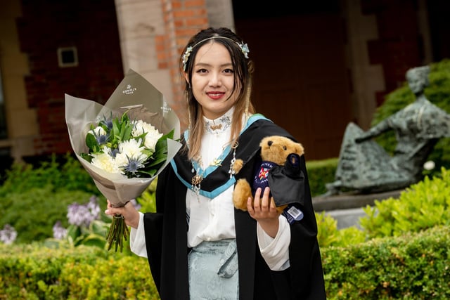 Yue Liu pictured in Chinese traditional dress as she graduates from the School of Mathematics and Physics at Queen’s