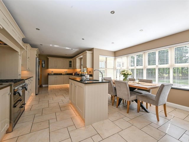 Open-plan kitchen/dining area with tiled flooring throughout.