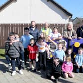 Mayor of Causeway Coast and Glens, Councillor Ciarán McQuillan, pictured with Lindsay Hutchinson, Estates Technical Officer, Martin McHenry, Estates Outdoor Facilities Inspector, Councillor Maighread Watson and local primary school children at the official opening of the reinstated play park at Scally Park in Loughguile.
