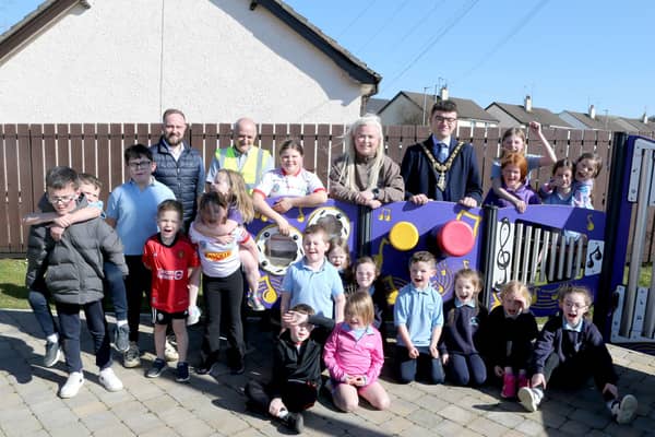 Mayor of Causeway Coast and Glens, Councillor Ciarán McQuillan, pictured with Lindsay Hutchinson, Estates Technical Officer, Martin McHenry, Estates Outdoor Facilities Inspector, Councillor Maighread Watson and local primary school children at the official opening of the reinstated play park at Scally Park in Loughguile.