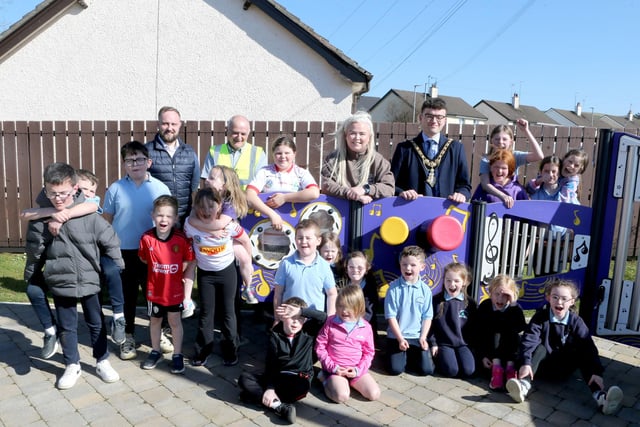 Mayor of Causeway Coast and Glens, Councillor Ciarán McQuillan, pictured with Lindsay Hutchinson, Estates Technical Officer, Martin McHenry, Estates Outdoor Facilities Inspector, Councillor Maighread Watson and local primary school children at the official opening of the reinstated play park at Scally Park in Loughguile.