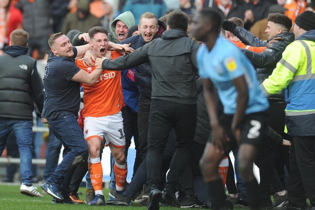 Jordan Thompson is mobbed as fans spilled onto the pitch to celebrate