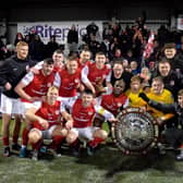 Larne players celebrate the win at Seaview. (Pic by Bill Guiller).