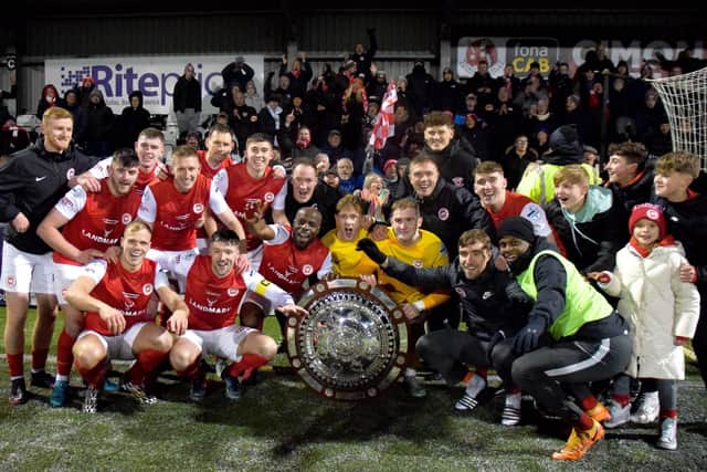 Larne players celebrate the win at Seaview. (Pic by Bill Guiller).