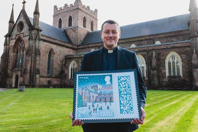 The Dean of Armagh, the Very Rev Shane Forster, with the new Christmas stamp featuring St Patrick's Church of Ireland Cathedral in Armagh. Picture: SWNS