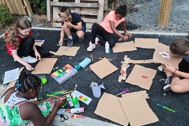 Children unite to paint flags at a Portadown estate complex which hosted a multi-cultural street party with food, music and fun from across the globe.