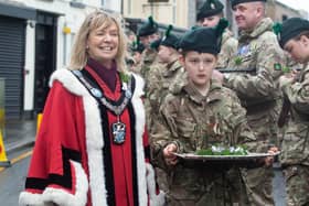 Making her way around the ranks with shamrock sprigs and the help of a young Army Cadet is Lord Mayor of ABC Council, Alderman Margaret Tinsley. PT12-206.
