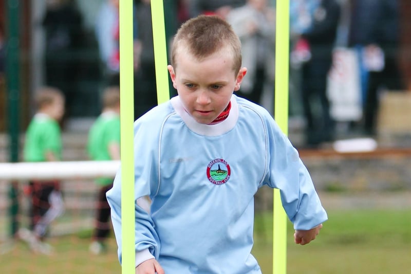 Aaron Mills weaves through the slalom poles at a Greenisland FC fun day. INLT 19-411-RM