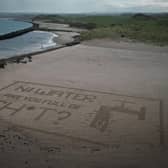 Act Now's sand art stunt targeting NI Water at Castlerock Beach last Saturday