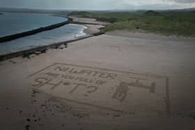Act Now's sand art stunt targeting NI Water at Castlerock Beach last Saturday