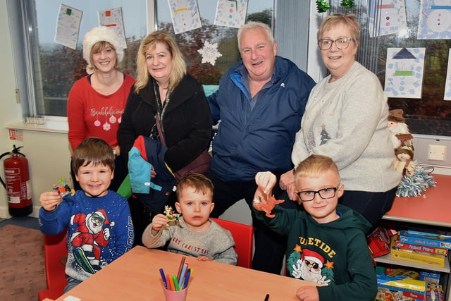 Pictured at The Cope Primary School, Loughgall, festive afternoon are, back row from left, Connie Brown, classroom assistant, Mary and Charles Maye and Thelma  McMinn, classroom assistant. Front, from left, Isaac Miller (5), Rowan Murphy (3) and Bailey Murphy (7). PT51-206.