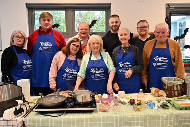 Residents learn new skills and knowledge about food at a healthy eating workshop. Pictured include Maire Scott, from Lagmore Community Forum (front row, left), and Stuart Lavery, Housing Executive Good Relations Officer (back row, right). Pic credit: Simon Graham