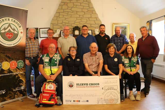 Brian McGrillen, chairman of the Dromara Vintage and Classic Club, presenting the sponsorship cheque to Loretta Gribben, chair of the Slieve Croob Community First Responders. Also in the picture are (from left) Responders Barry McEvoy and Nieve O'Halloran and the group's treasurer Patricia Quinn. Pic credit: Dromara Vintage and Classic Club